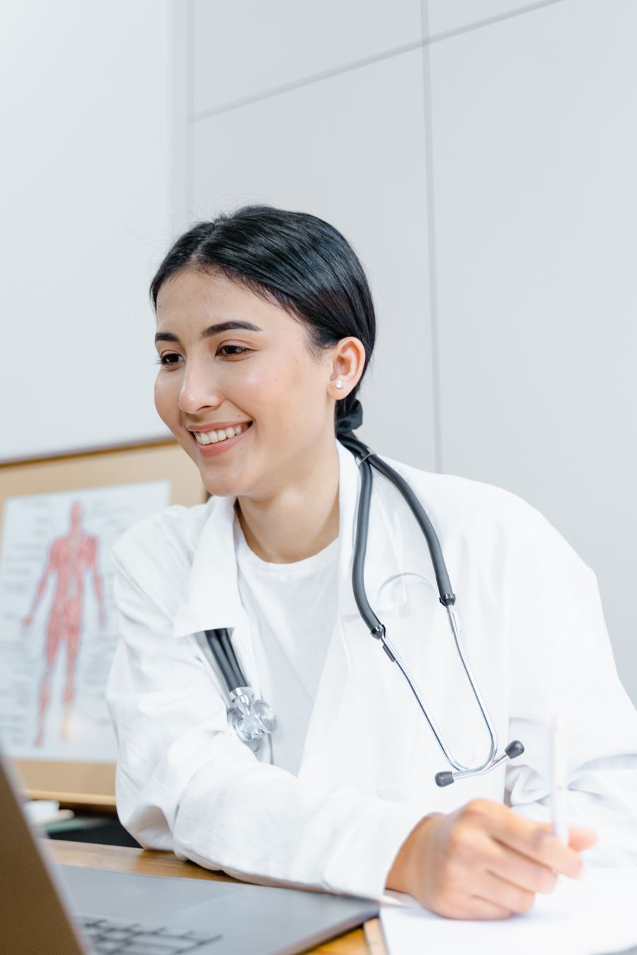 Female doctor conducting an online patient consultation on a laptop